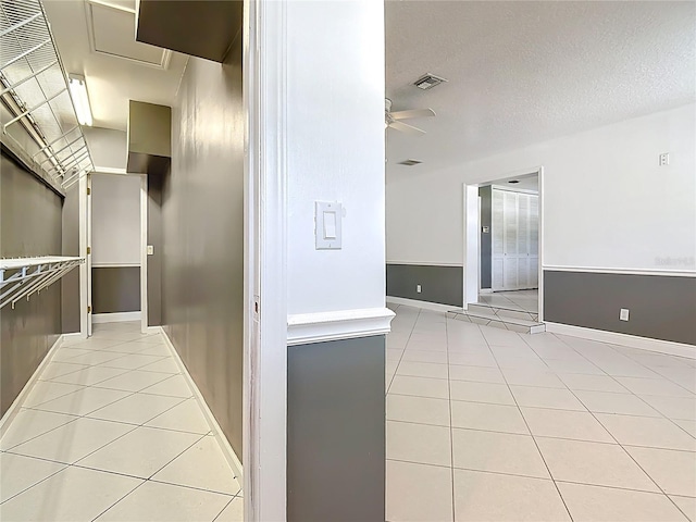 3417 Pershing Ave, Orlando, FL 32812 - kitchen with light tile patterned floors, ceiling fan, light countertops, and a textured ceiling