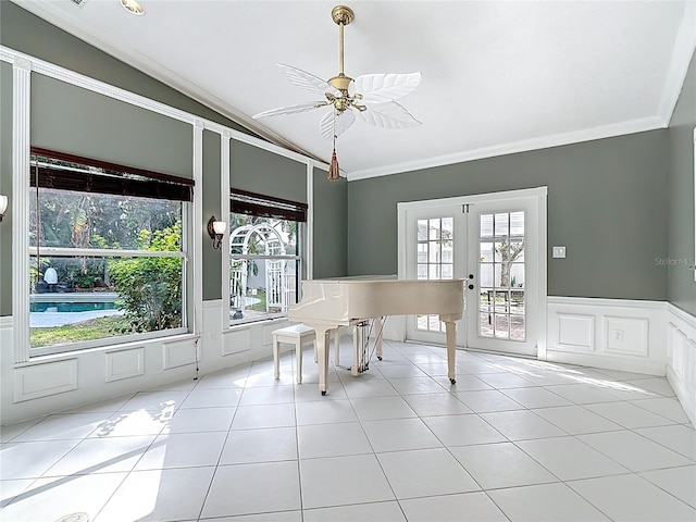 3417 Pershing Ave, Orlando, FL 32812 - tiled dining area with vaulted ceiling, ornamental molding, a decorative wall, healthy amount of natural light, and french doors