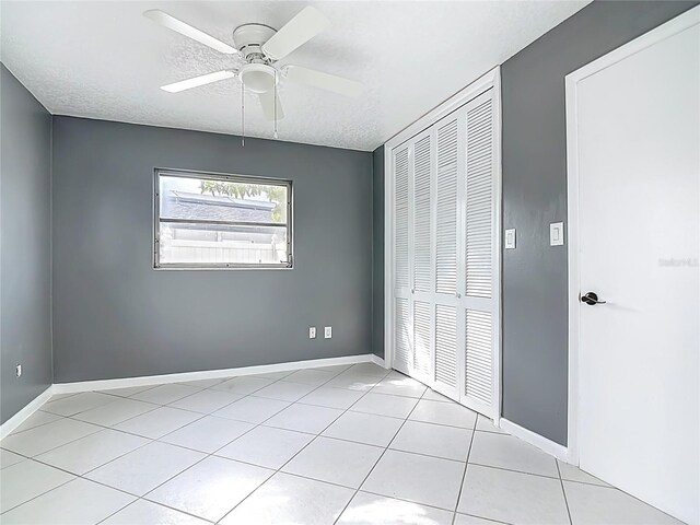 3417 Pershing Ave, Orlando, FL 32812 - unfurnished bedroom with a closet, light tile patterned flooring, a textured ceiling, and ceiling fan