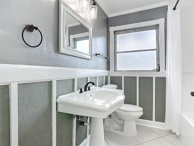 3417 Pershing Ave, Orlando, FL 32812 - bathroom featuring a decorative wall, tile patterned floors, shower / tub combo, ornamental molding, and a wainscoted wall