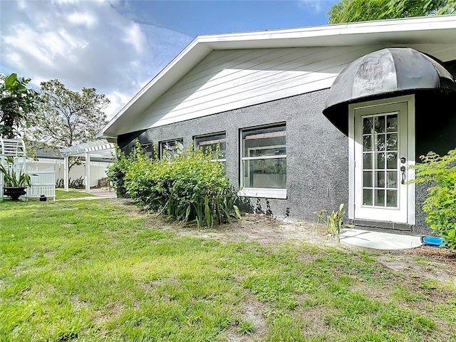 3417 Pershing Ave, Orlando, FL 32812 - view of property exterior featuring a pergola and a yard