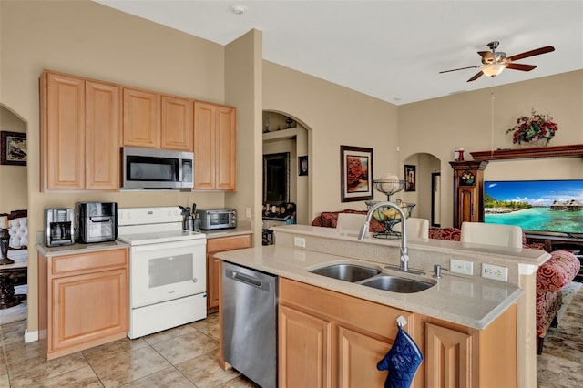 501 Lake Cummings Way, Lake Alfred, FL 33850 - kitchen with stainless steel appliances, light brown cabinets, arched walkways, light countertops, and a ceiling fan