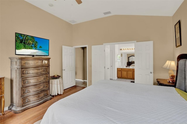 501 Lake Cummings Way, Lake Alfred, FL 33850 - bedroom with light wood-style flooring, connected bathroom, ceiling fan, and high vaulted ceiling