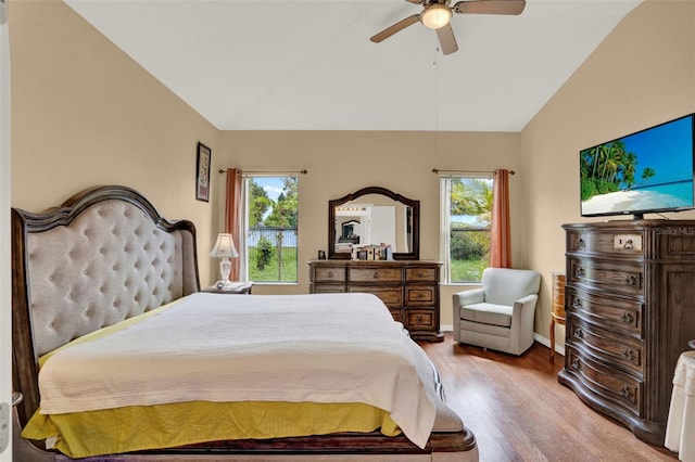 501 Lake Cummings Way, Lake Alfred, FL 33850 - bedroom with vaulted ceiling, wood finished floors, multiple windows, and a ceiling fan