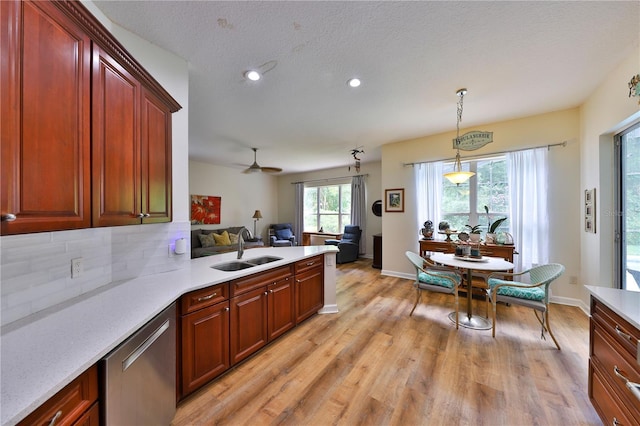 604 Timberwilde Ct, Winter Springs, FL 32708 - kitchen with dishwasher, light wood-style floors, light countertops, recessed lighting, and decorative backsplash