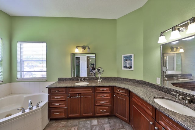 604 Timberwilde Ct, Winter Springs, FL 32708 - bathroom with double vanity, a garden tub, and stone finish floors