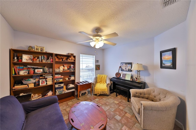 604 Timberwilde Ct, Winter Springs, FL 32708 - sitting room featuring ceiling fan, a textured ceiling, and light stone finish floors