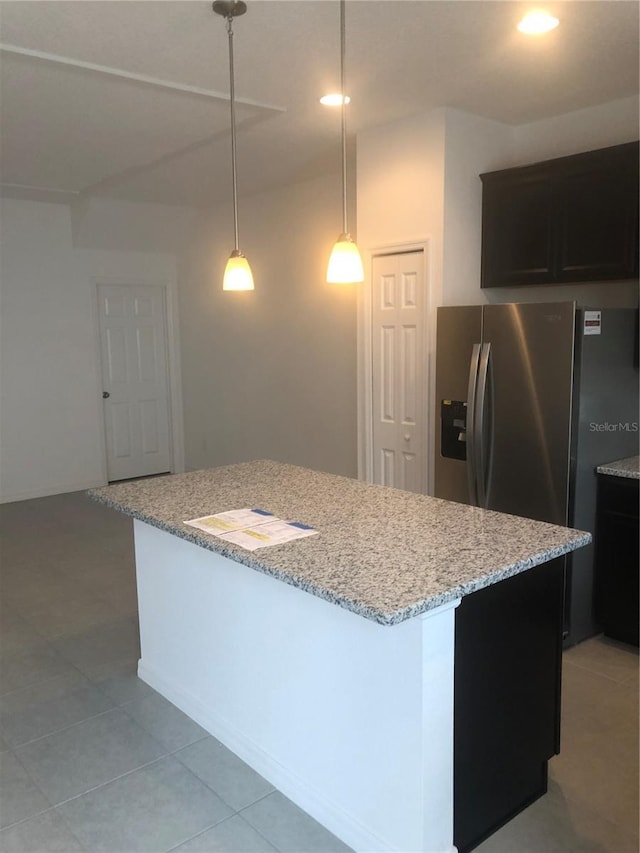 1003 E 10th St, Apopka, FL 32703 - kitchen with stainless steel fridge with ice dispenser, a center island, light stone counters, recessed lighting, and hanging light fixtures