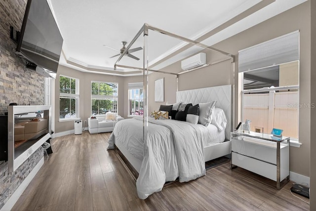533 Quail Down Dr, Debary, FL 32713 - bedroom featuring wood finished floors, a tray ceiling, and an AC wall unit