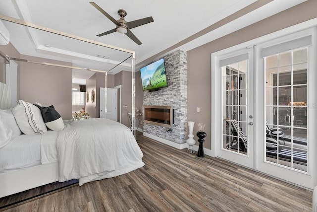 533 Quail Down Dr, Debary, FL 32713 - bedroom featuring wood finished floors, access to exterior, a stone fireplace, and ceiling fan