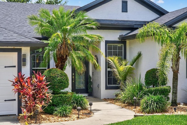 533 Quail Down Dr, Debary, FL 32713 - entrance to property with stucco siding, roof with shingles, and a garage