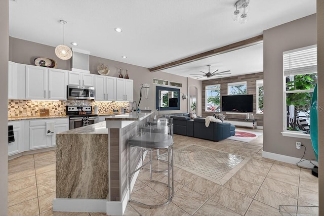 533 Quail Down Dr, Debary, FL 32713 - kitchen with appliances with stainless steel finishes, decorative backsplash, white cabinets, a ceiling fan, and recessed lighting