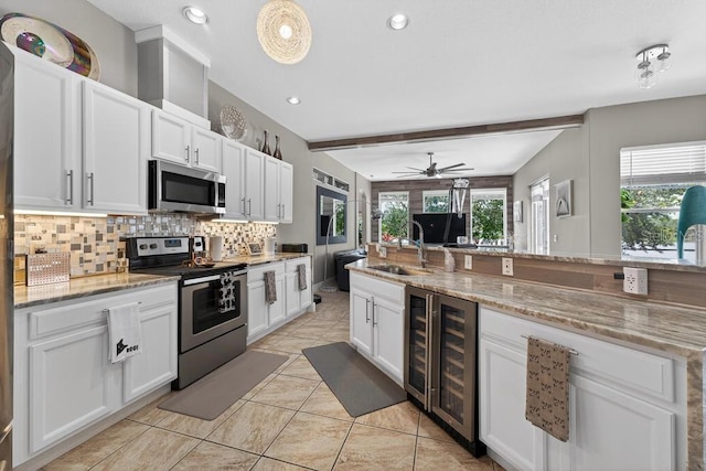 533 Quail Down Dr, Debary, FL 32713 - kitchen with stainless steel appliances, wine cooler, tasteful backsplash, white cabinetry, and a ceiling fan