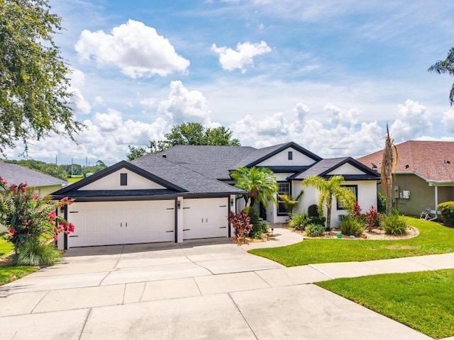 533 Quail Down Dr, Debary, FL 32713 - ranch-style house featuring concrete driveway, an attached garage, stucco siding, a front yard, and a shingled roof