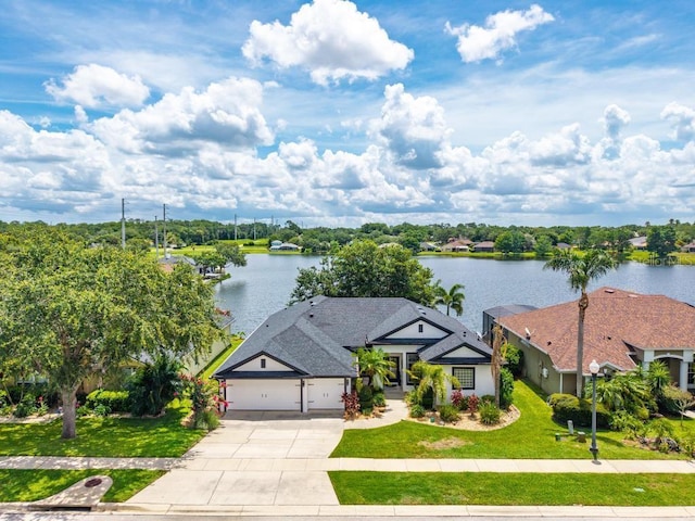533 Quail Down Dr, Debary, FL 32713 - view of front of house with a water view, concrete driveway, a garage, and a front lawn