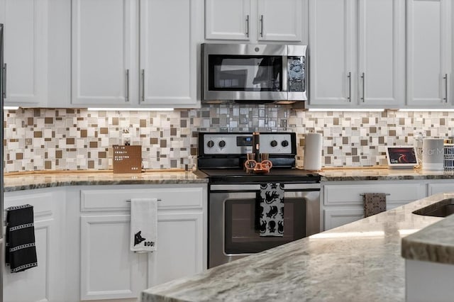 533 Quail Down Dr, Debary, FL 32713 - kitchen with appliances with stainless steel finishes and white cabinets
