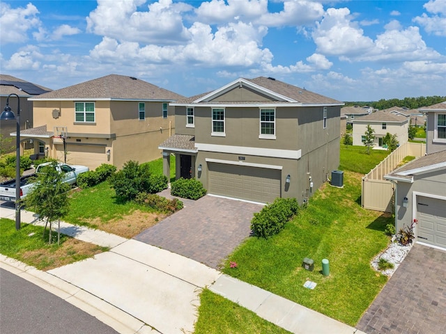 2817 Muller Oak Loop, Ocoee, FL 34761 - view of front facade featuring stucco siding, a garage, decorative driveway, a residential view, and a front lawn