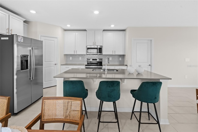 2817 Muller Oak Loop, Ocoee, FL 34761 - kitchen featuring stainless steel appliances, a kitchen breakfast bar, tasteful backsplash, white cabinets, and recessed lighting