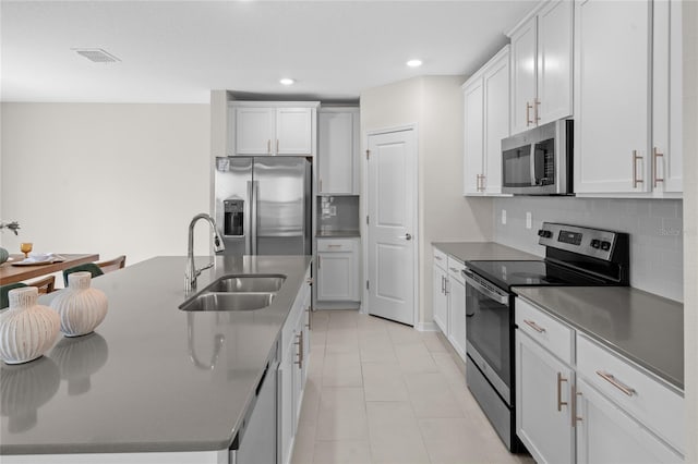 2817 Muller Oak Loop, Ocoee, FL 34761 - kitchen featuring stainless steel appliances, tasteful backsplash, light tile patterned floors, a center island with sink, and recessed lighting