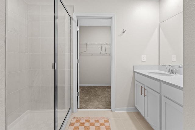 2817 Muller Oak Loop, Ocoee, FL 34761 - bathroom with a stall shower, vanity, a walk in closet, and tile patterned floors