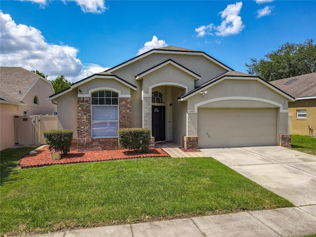 12938 Maribou Cir, Orlando, FL 32828 - ranch-style home featuring stucco siding, a garage, concrete driveway, and brick siding