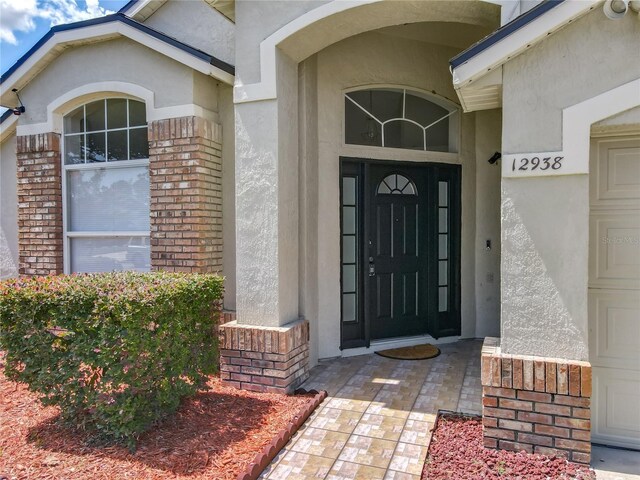 12938 Maribou Cir, Orlando, FL 32828 - entrance to property with stucco siding and brick siding