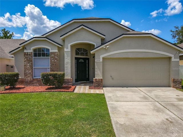 12938 Maribou Cir, Orlando, FL 32828 - ranch-style home featuring stucco siding, a front yard, an attached garage, concrete driveway, and brick siding