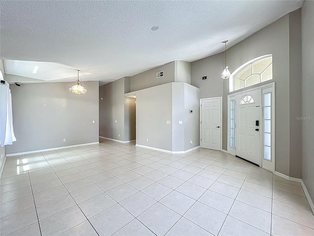 12938 Maribou Cir, Orlando, FL 32828 - entryway featuring light tile patterned floors, a textured ceiling, and high vaulted ceiling