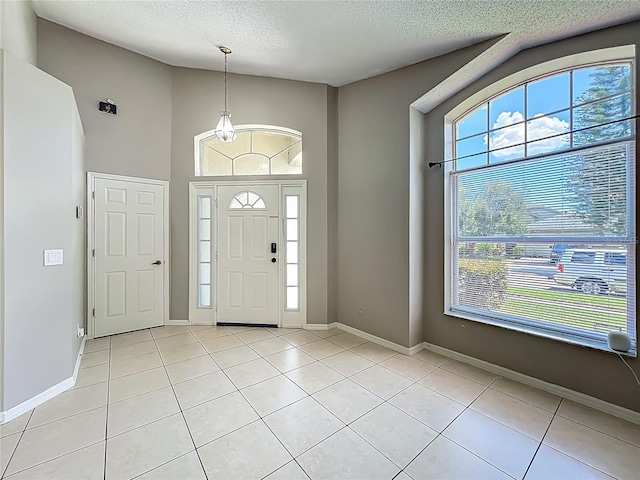 12938 Maribou Cir, Orlando, FL 32828 - entryway with a textured ceiling, healthy amount of natural light, light tile patterned flooring, and high vaulted ceiling
