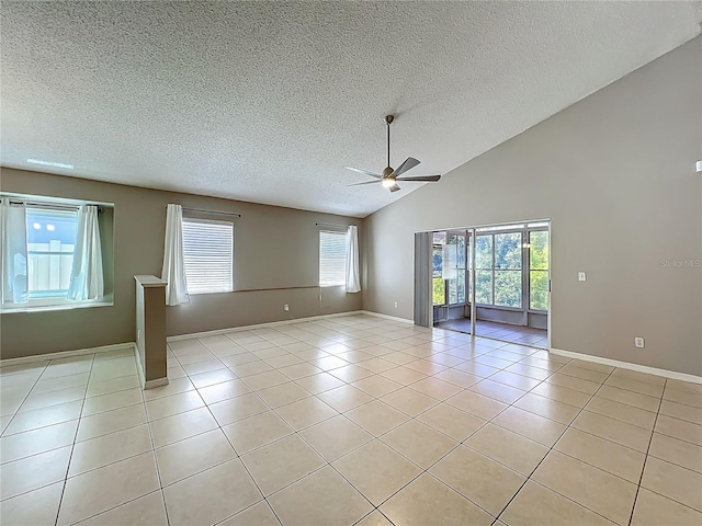 12938 Maribou Cir, Orlando, FL 32828 - spare room with ceiling fan, healthy amount of natural light, a textured ceiling, light tile patterned floors, and high vaulted ceiling