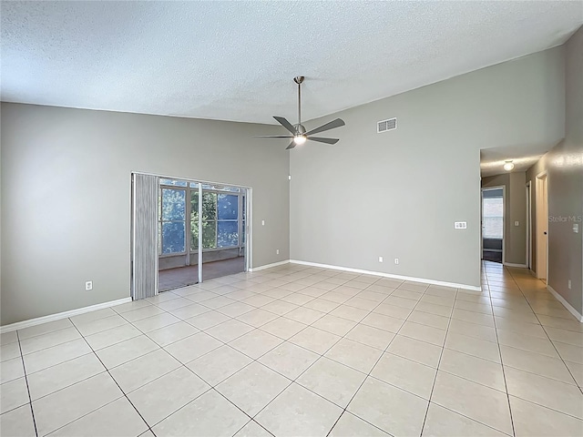 12938 Maribou Cir, Orlando, FL 32828 - empty room featuring ceiling fan, light tile patterned flooring, a textured ceiling, and high vaulted ceiling