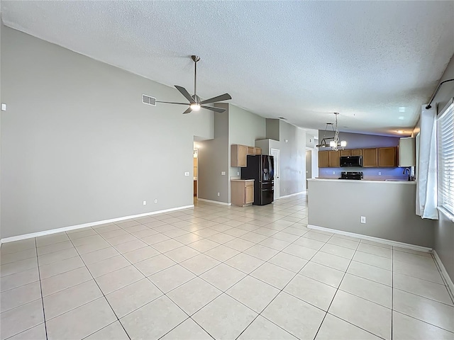 12938 Maribou Cir, Orlando, FL 32828 - unfurnished living room with lofted ceiling, a textured ceiling, a chandelier, ceiling fan, and light tile patterned floors