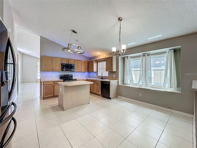 12938 Maribou Cir, Orlando, FL 32828 - kitchen with black appliances, a textured ceiling, lofted ceiling, light countertops, and a kitchen island