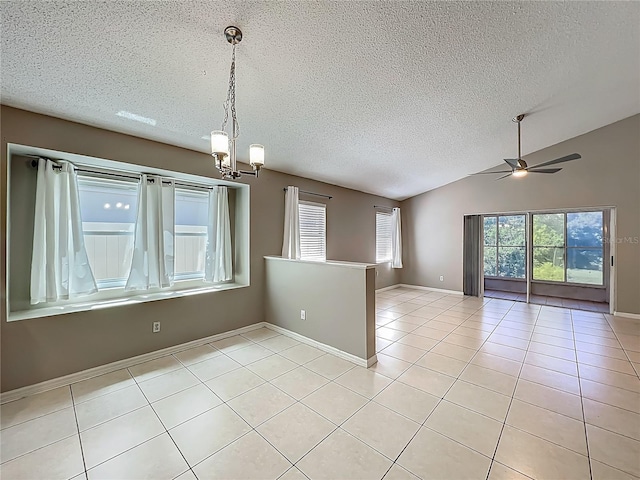 12938 Maribou Cir, Orlando, FL 32828 - empty room with a chandelier, light tile patterned flooring, a textured ceiling, vaulted ceiling, and ceiling fan