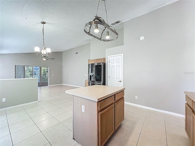 12938 Maribou Cir, Orlando, FL 32828 - kitchen featuring stainless steel fridge with ice dispenser, a chandelier, a textured ceiling, light tile patterned flooring, and light countertops