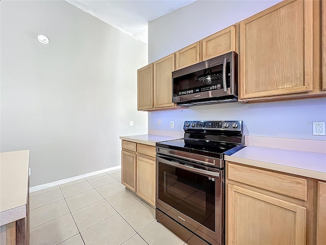 12938 Maribou Cir, Orlando, FL 32828 - kitchen featuring appliances with stainless steel finishes, light brown cabinets, light countertops, and light tile patterned floors
