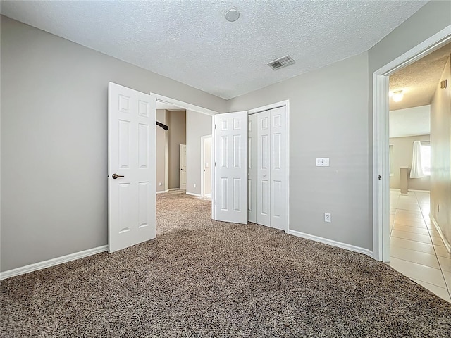 12938 Maribou Cir, Orlando, FL 32828 - unfurnished bedroom with carpet floors, a textured ceiling, and a closet