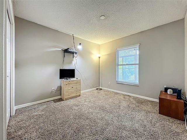 12938 Maribou Cir, Orlando, FL 32828 - unfurnished bedroom featuring a textured ceiling, carpet floors, and an office area