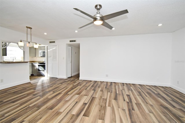 3057 Aaron Burr Ave Unit 1, Winter Park, FL 32792 - unfurnished living room featuring dark wood-style flooring, recessed lighting, a ceiling fan, and a textured ceiling