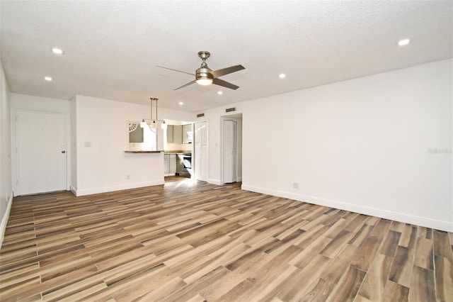 3057 Aaron Burr Ave Unit 1, Winter Park, FL 32792 - unfurnished living room with recessed lighting, wood finished floors, a ceiling fan, and a textured ceiling