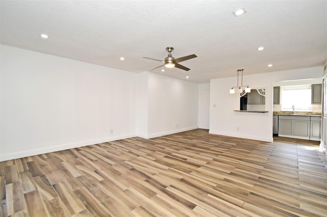 3057 Aaron Burr Ave Unit 1, Winter Park, FL 32792 - unfurnished living room featuring recessed lighting, ceiling fan, light wood-type flooring, and a textured ceiling