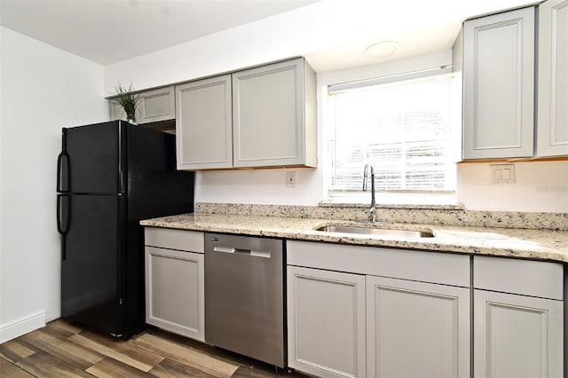 3057 Aaron Burr Ave Unit 1, Winter Park, FL 32792 - kitchen with dishwasher, freestanding refrigerator, wood finished floors, and light stone counters