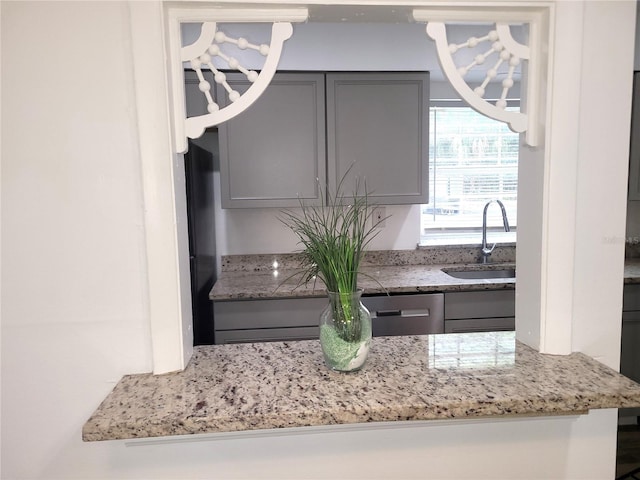 3057 Aaron Burr Ave Unit 1, Winter Park, FL 32792 - kitchen featuring gray cabinets, a chandelier, and light stone countertops