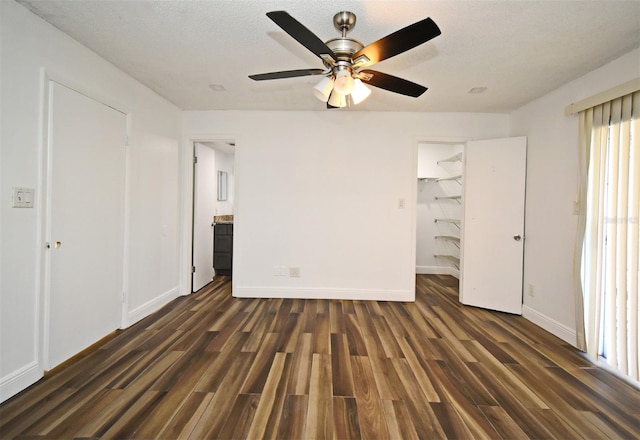 3057 Aaron Burr Ave Unit 1, Winter Park, FL 32792 - unfurnished bedroom featuring dark wood-style floors, a walk in closet, a closet, a ceiling fan, and ensuite bath