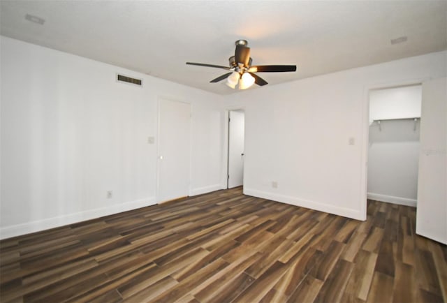 3057 Aaron Burr Ave Unit 1, Winter Park, FL 32792 - unfurnished bedroom with dark wood finished floors, ceiling fan, a closet, and a walk in closet