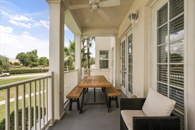 7509 Mourning Dove Cir Unit 204, Reunion, FL 34747 - balcony featuring french doors, a ceiling fan, and outdoor dining area