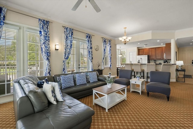 7509 Mourning Dove Cir Unit 204, Reunion, FL 34747 - living area featuring a chandelier, crown molding, a ceiling fan, and light colored carpet
