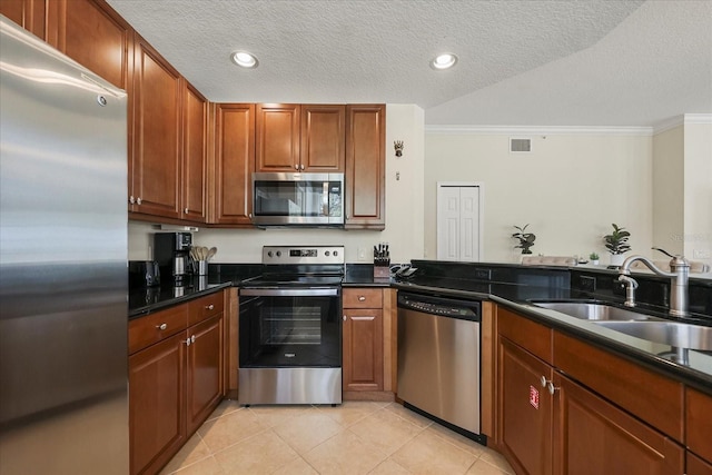 7509 Mourning Dove Cir Unit 204, Reunion, FL 34747 - kitchen with appliances with stainless steel finishes, ornamental molding, light tile patterned floors, a textured ceiling, and dark countertops