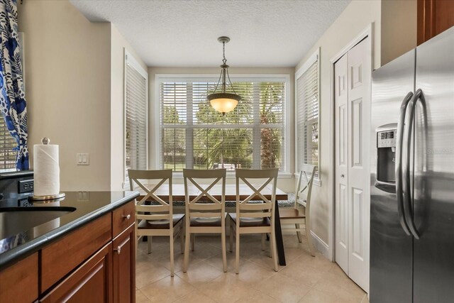 7509 Mourning Dove Cir Unit 204, Reunion, FL 34747 - dining area with light tile patterned floors and a textured ceiling