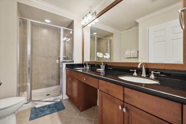 7509 Mourning Dove Cir Unit 204, Reunion, FL 34747 - bathroom with crown molding, double vanity, a shower stall, and tile patterned floors